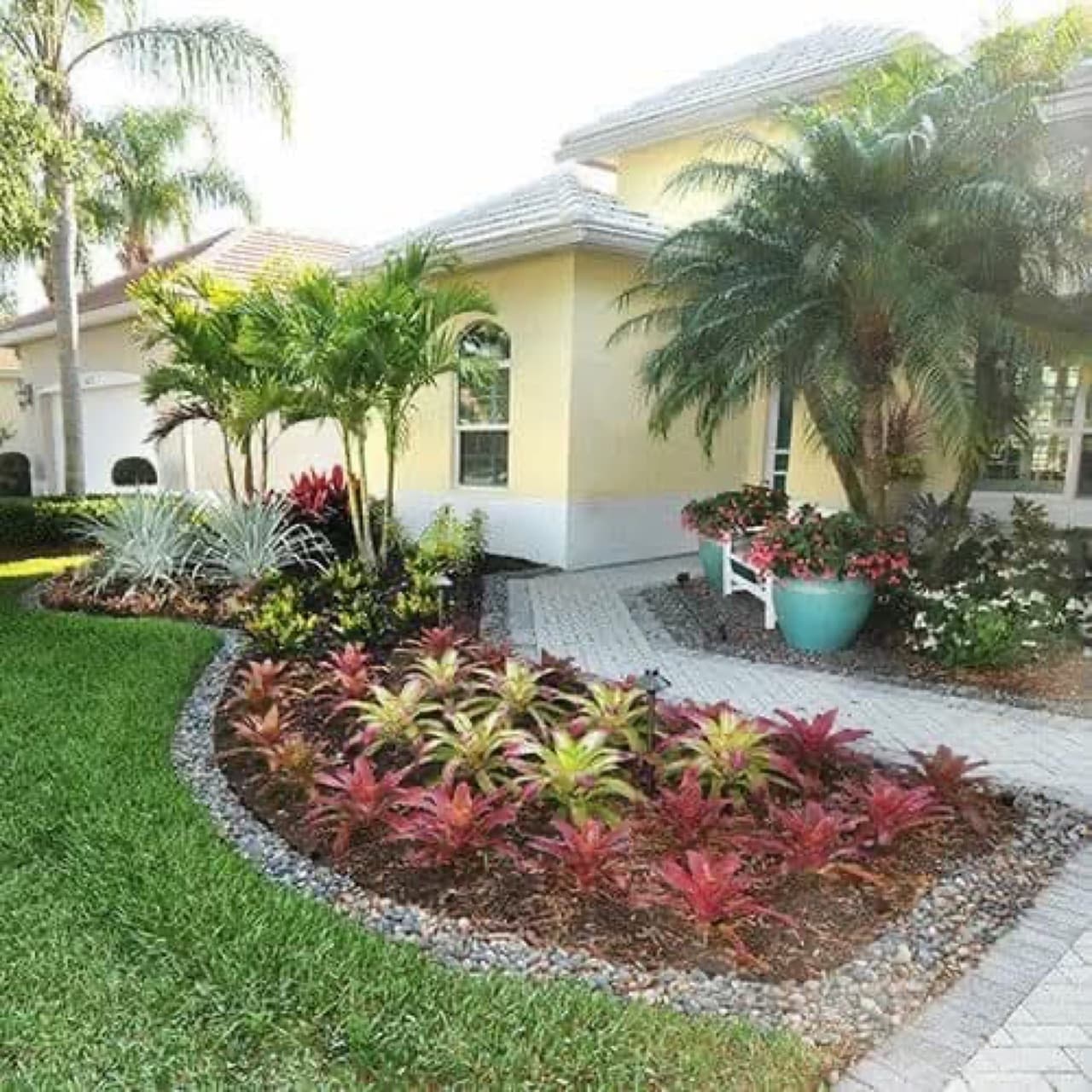 Neatly landscaped garden with flowering beds and trimmed hedges after tree care